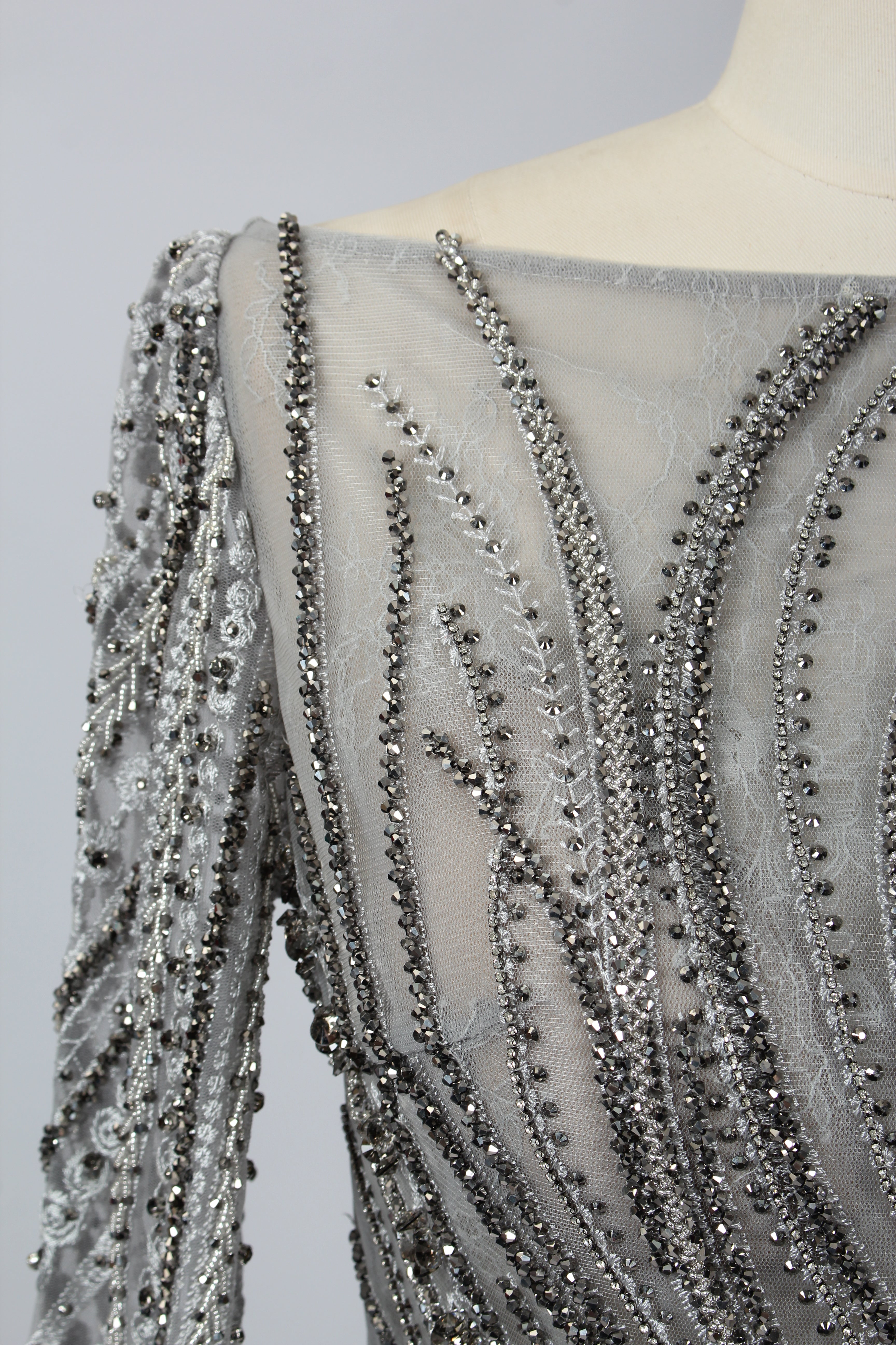 Backless silver-grey beaded long-sleeve evening dress with deep V bead straps