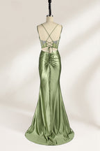 A mannequin presents a green satin gown with a bejeweled, sheer bodice against a light backdrop. It features thin straps, a sweetheart neckline, and a mermaid - shaped skirt. The sparkling embellishments and smooth fabric exude elegance, perfect for formal galas.2