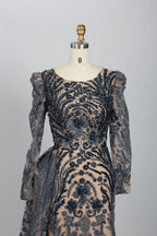 Navy lace mermaid gown with ornate beaded bodice and puffed sheer sleeve details