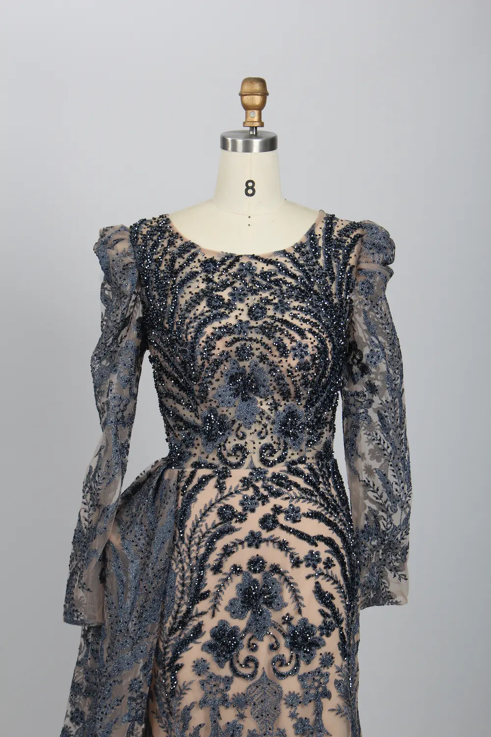 Navy lace mermaid gown with ornate beaded bodice and puffed sheer sleeve details