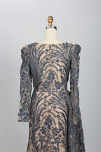 Back view of navy lace mermaid formal dress with sheer long sleeves and cape