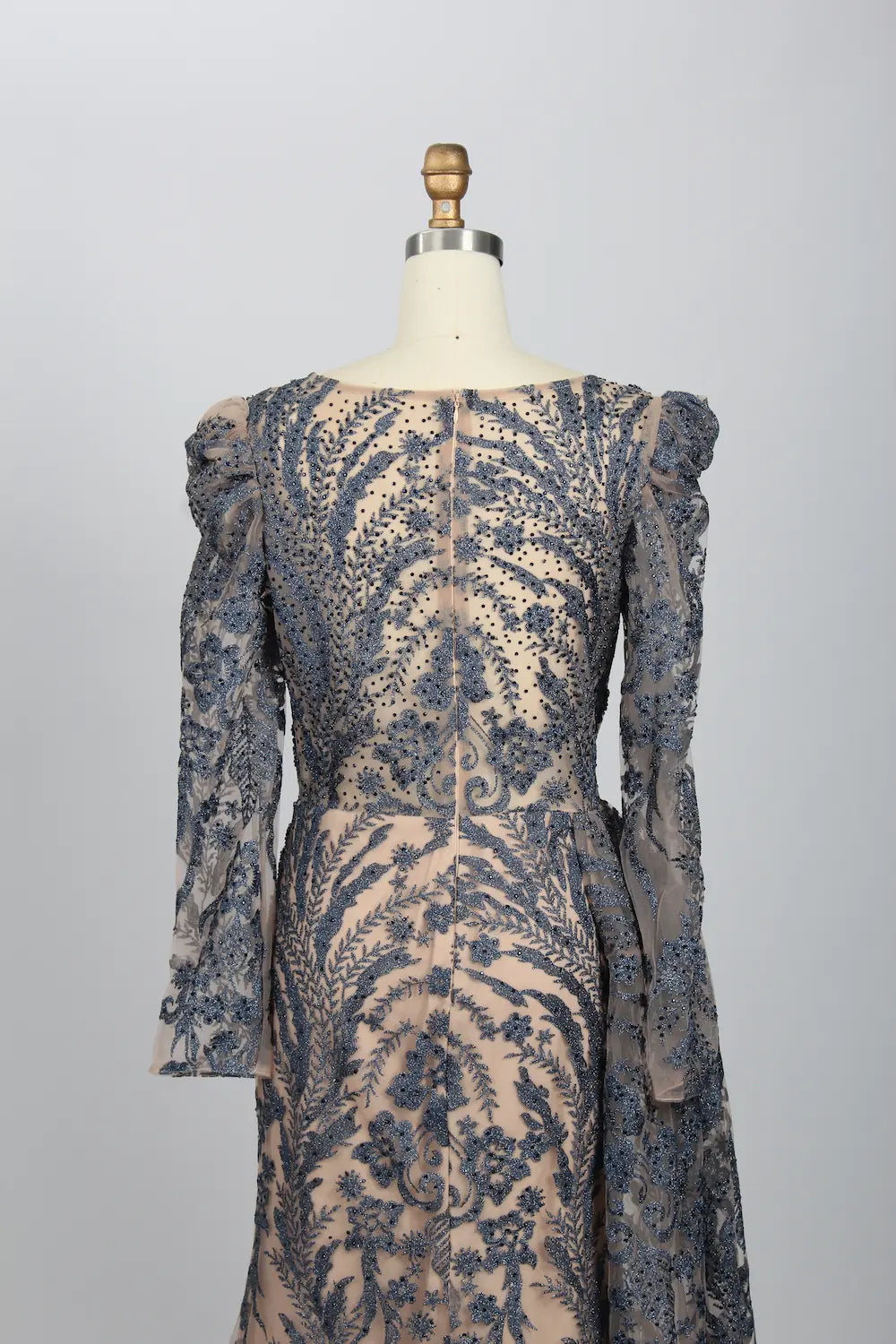 Back view of navy lace mermaid formal dress with sheer long sleeves and cape