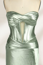 A mannequin showcases a strapless light - green satin gown against a soft, neutral backdrop. The dress features a twisted, criss - cross bodice with a subtle sheer panel and a mermaid silhouette, complete with a high side slit and a flowing train. The smooth, lustrous satin fabric and elegant design exude sophistication, perfect for formal galas or black - tie events.21
