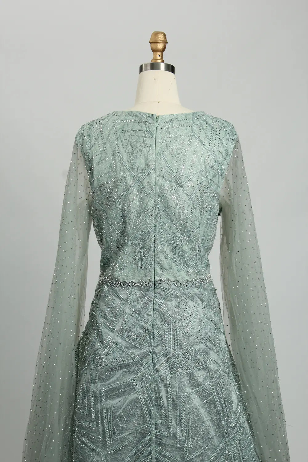 Teal beaded A-line dress with long sheer sleeves and vertical back seam