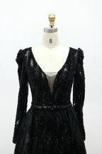 Black long-sleeve sequin evening dress with V-neck bodice and puffed shoulders