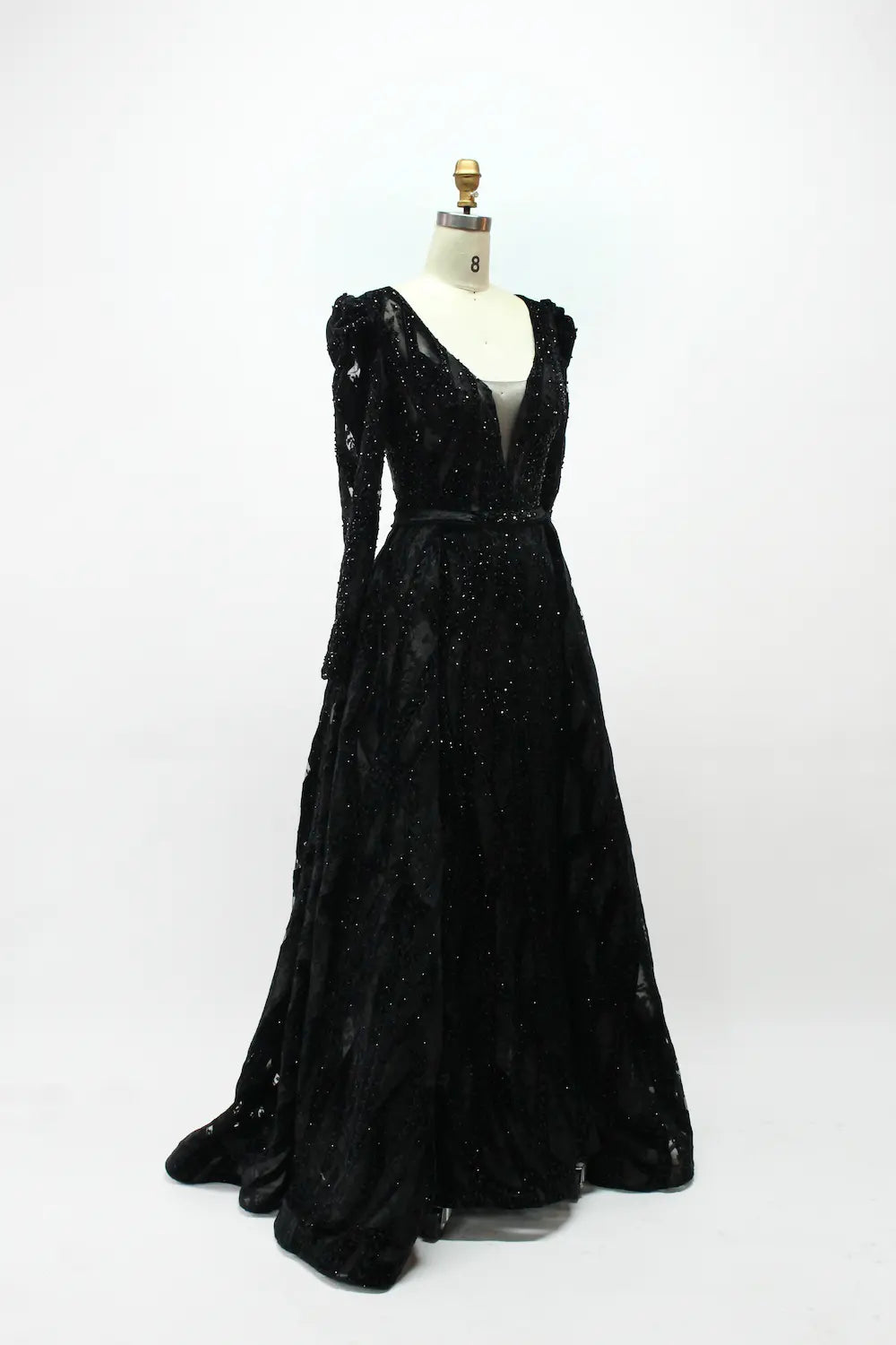 Black long-sleeve sequined evening dress with fitted waist and full skirt