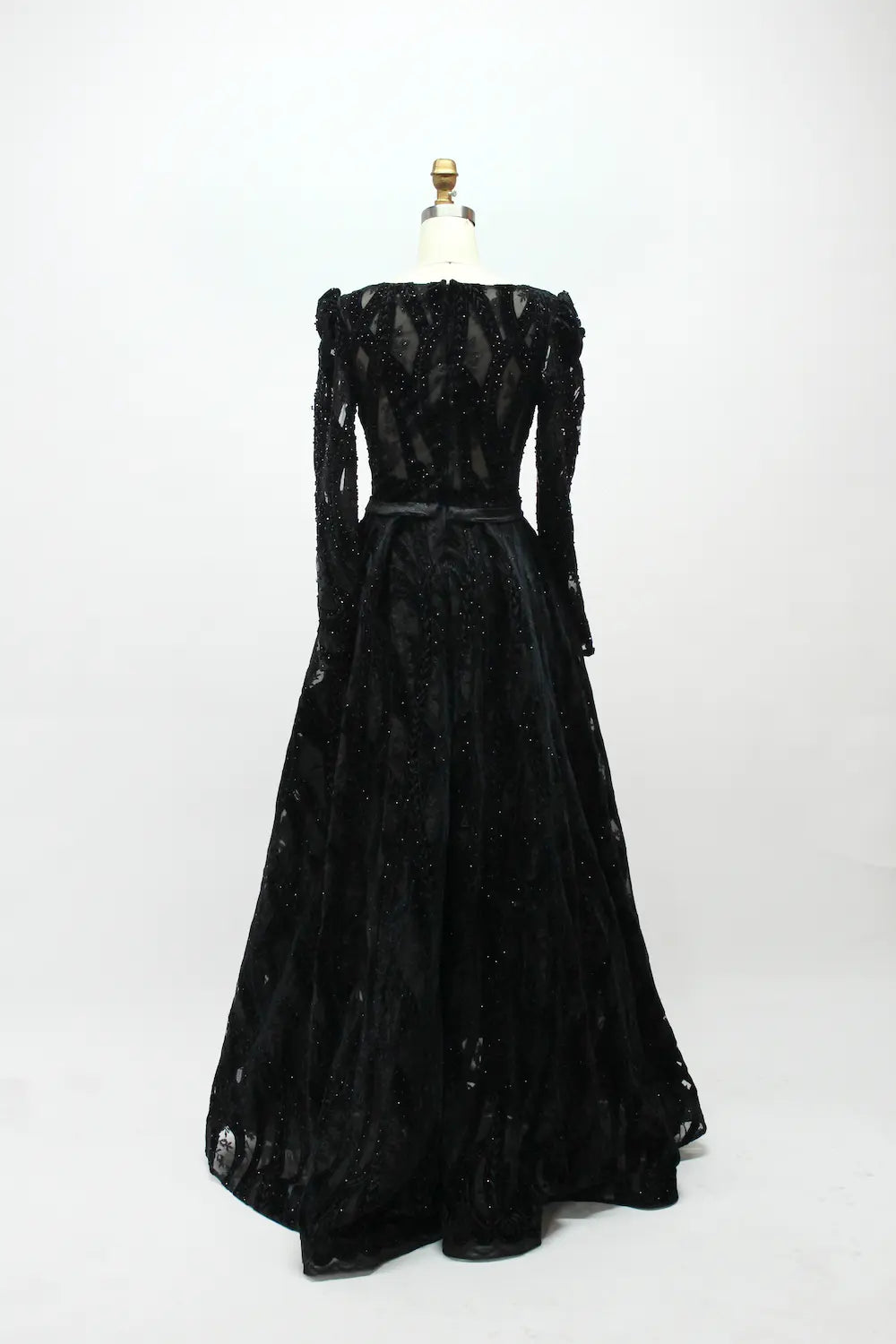 Black long-sleeve sequined evening dress with flared skirt and belted waist (back view)