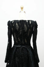 Black long-sleeve sequin back with sheer paneling and defined waist belt