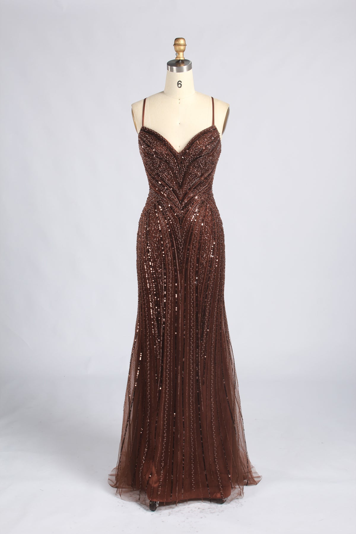 Brown beaded mermaid prom gown with a V-neck, spaghetti straps, and a fitted silhouette