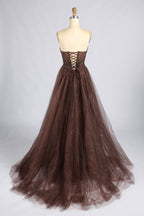 Back of the brown strapless prom dress, showing a lace-up bodice and full tulle skirt.