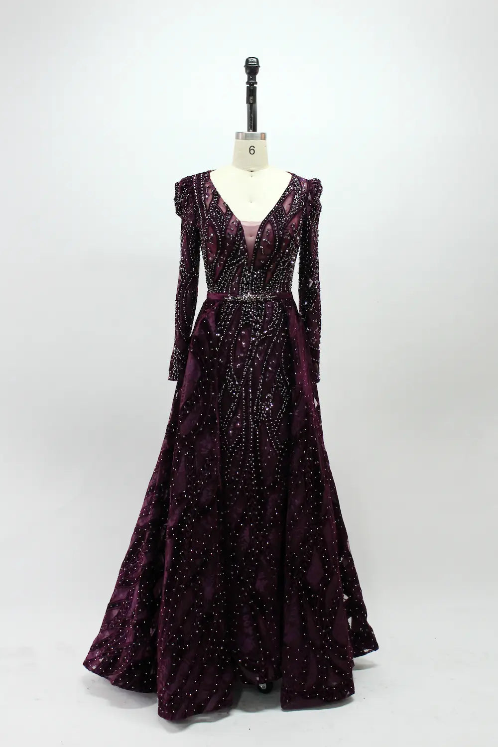 Burgundy long-sleeve sequin evening dress with V-neck and pleated flowing skirt