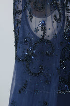 Close-up of navy beaded tulle bodice with floral swirl motifs and sparkling details
