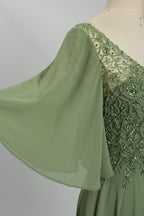 Sage green gown with embellished shoulder yoke and beaded V-neck detail