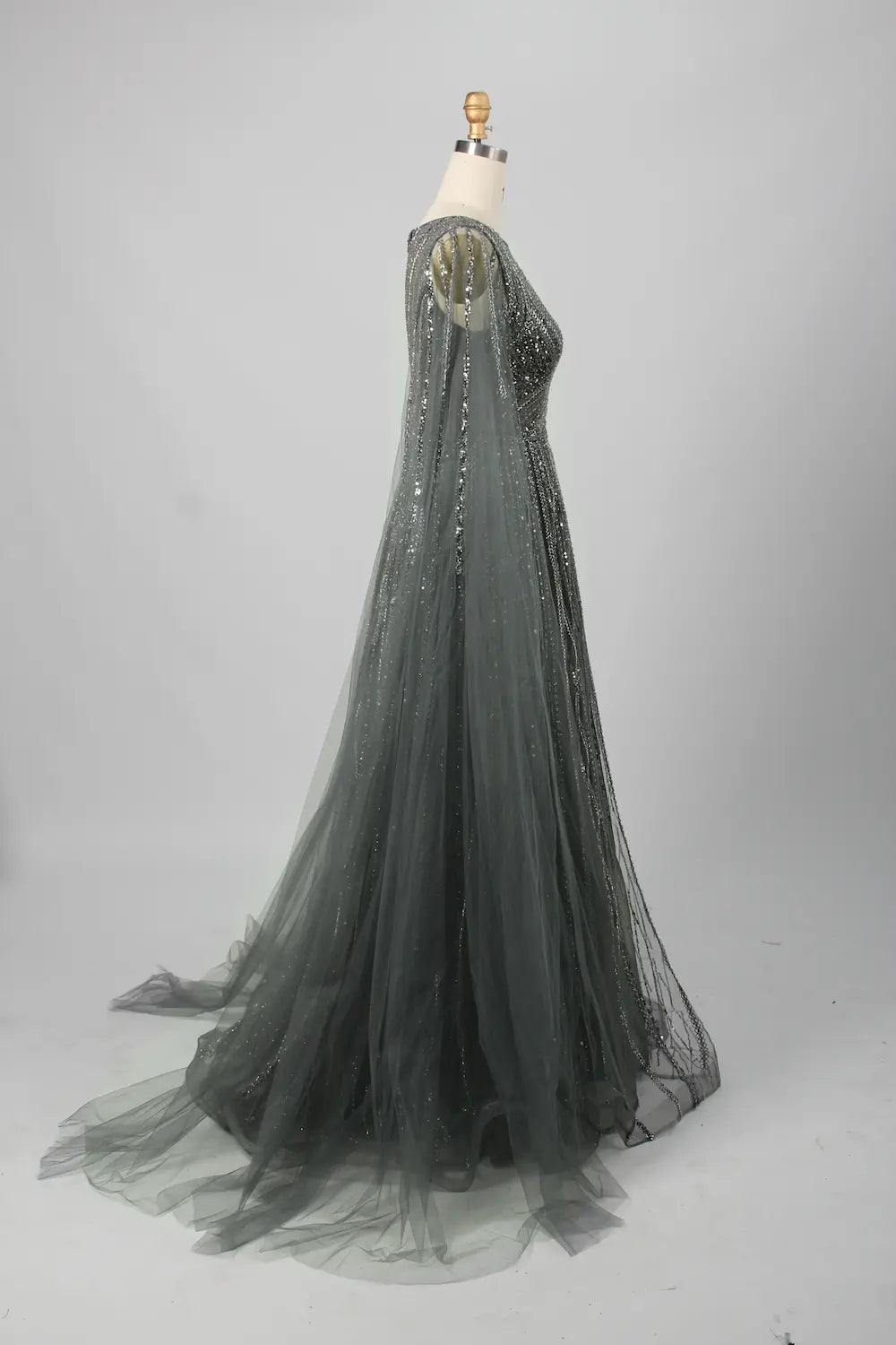 A-line beaded gown with sheer cape sleeves and V-back detail, dark metallic sparkle
