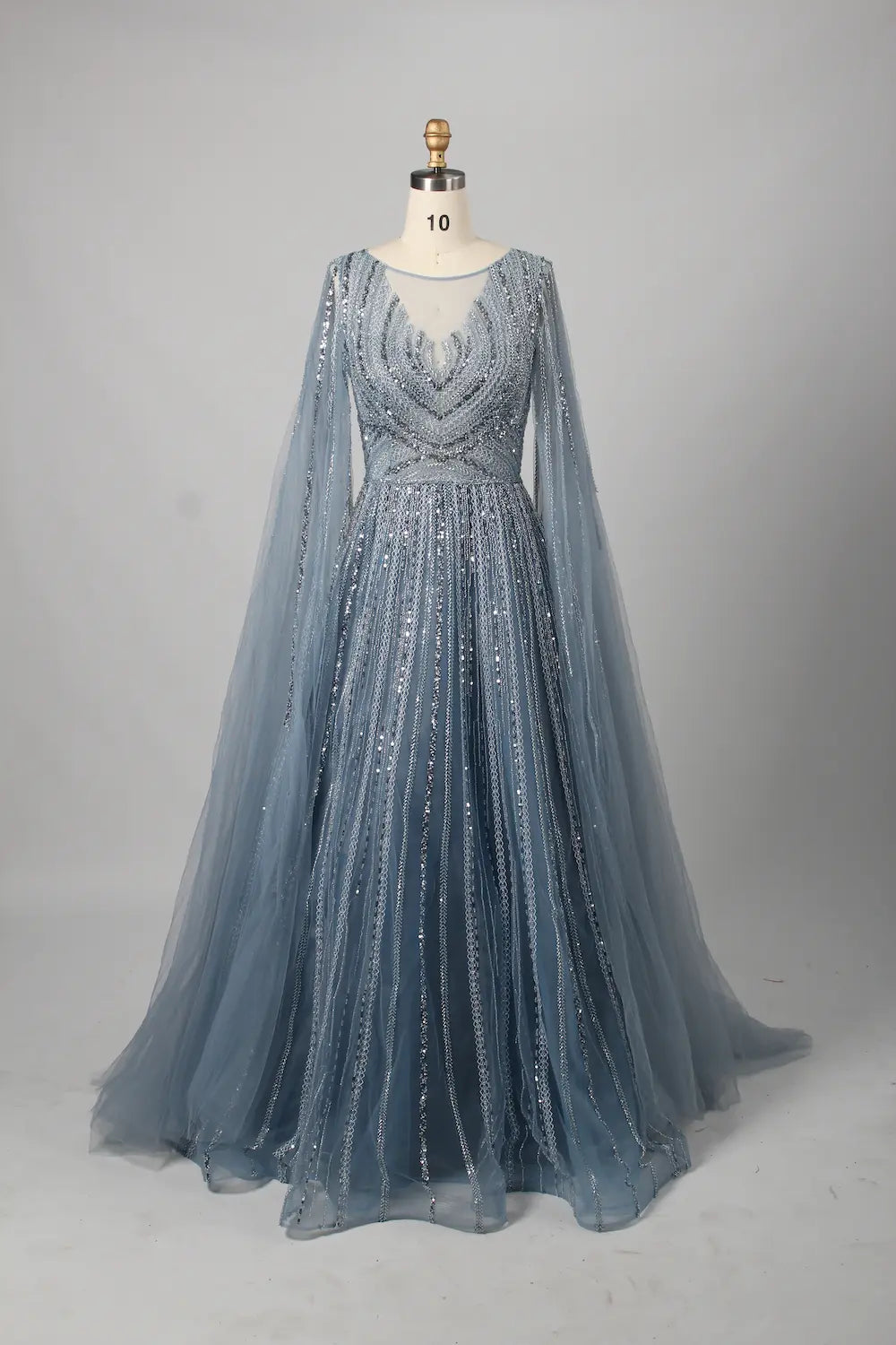 Beaded A-line mother-of-the-bride dress with V neckline, long sheer cape sleeves, light blue sparkle