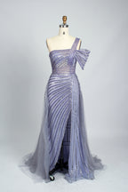 Against a light - hued backdrop, a woman dons a teal sequin gown with an one - shoulder design. It features a bow - detailed strap, a sheer waist panel, and a high side slit. The sparkling sequins and unique silhouette radiate glamour, perfect for formal dinners or galas.10