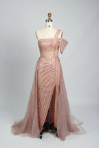 Against a light - hued backdrop, a woman dons a teal sequin gown with an one - shoulder design. It features a bow - detailed strap, a sheer waist panel, and a high side slit. The sparkling sequins and unique silhouette radiate glamour, perfect for formal dinners or galas.7