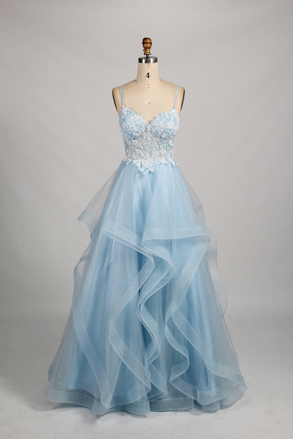 A mannequin displays a pink tulle gown. It features thin straps, a sweetheart neckline, intricate floral appliqués with sequins on the bodice, and a multi - layered, ruffled tulle skirt. The elegant design creates a romantic and glamorous look, perfect for formal events like proms or weddings.8