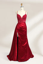 A mannequin showcases a royal - blue gown with thin straps. The bodice features intricate bead embroidery and sheer panels, while the skirt has a ruched design and a high side slit. The satin fabric and elegant details make it perfect for formal events like proms or galas, exuding sophistication.5