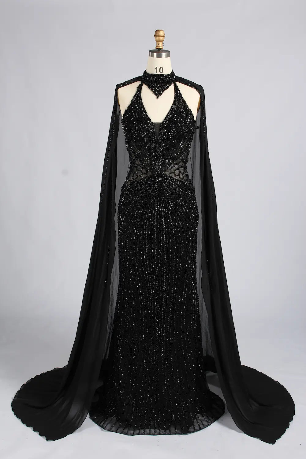 Black beaded halter mermaid gown with draped shoulder cape and V-neck detail
