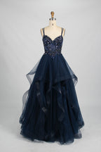 A mannequin displays a pink tulle gown. It features thin straps, a sweetheart neckline, intricate floral appliqués with sequins on the bodice, and a multi - layered, ruffled tulle skirt. The elegant design creates a romantic and glamorous look, perfect for formal events like proms or weddings.9