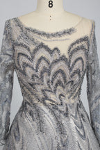 Silver sequin long sleeve evening dress with illusion neckline and zigzag pattern