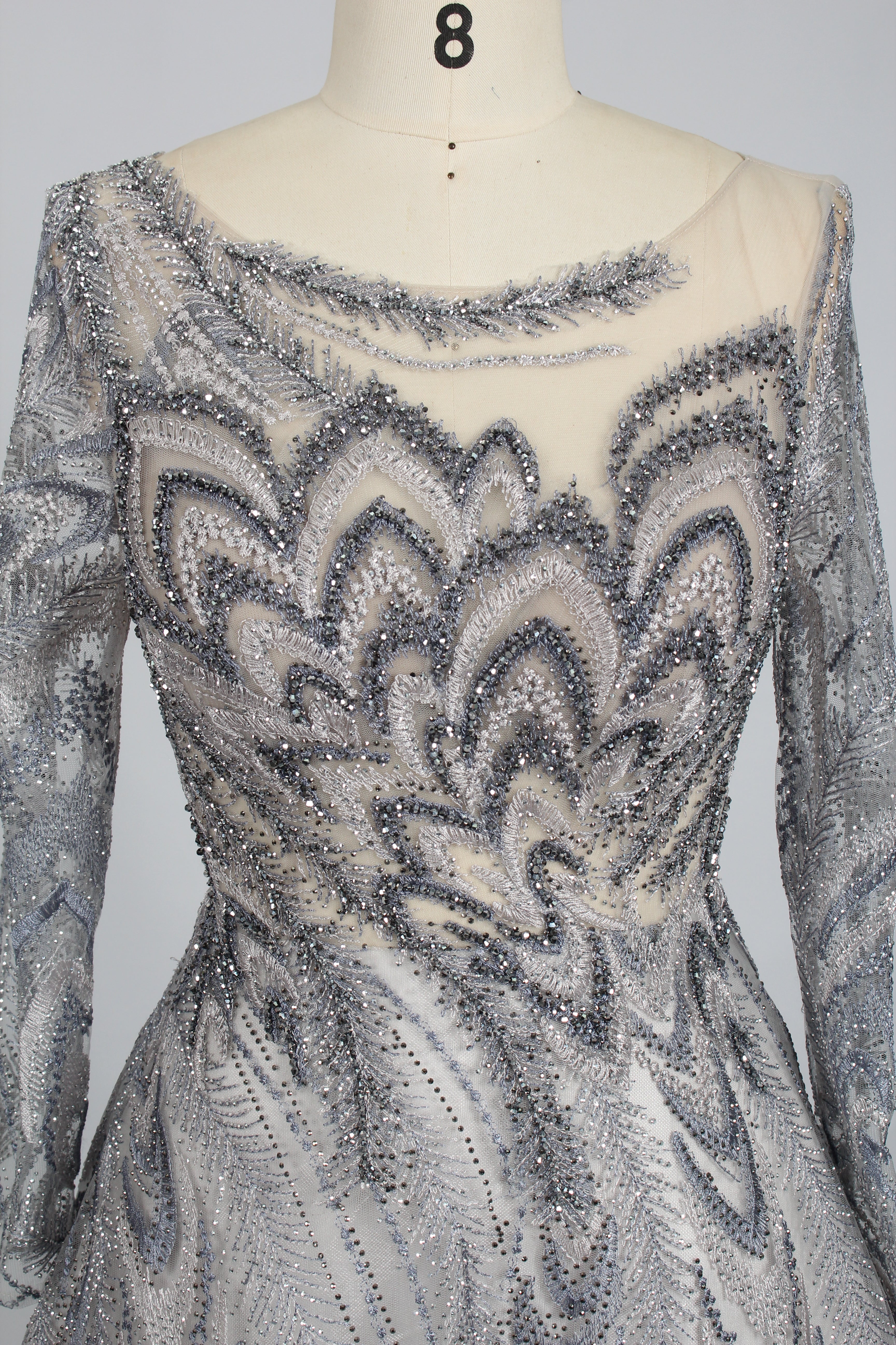Silver sequin long sleeve evening dress with illusion neckline and zigzag pattern