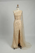 One-shoulder champagne sequin gown with high side slit and draped tulle train