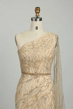 One-shoulder champagne sequin bodice with diagonal drape and sparkling beaded details