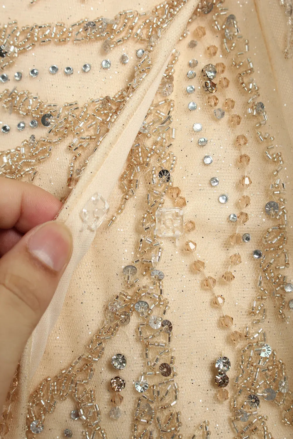 Champagne beaded sequin fabric with rhinestone accents for one-shoulder gown