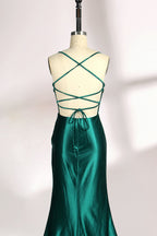 A mannequin displays a green satin gown against a light backdrop. It has thin straps, a sweetheart neckline, and a sheer bodice with beading. The mermaid skirt, featuring a high side slit, combines elegance and allure, perfect for formal galas.6 