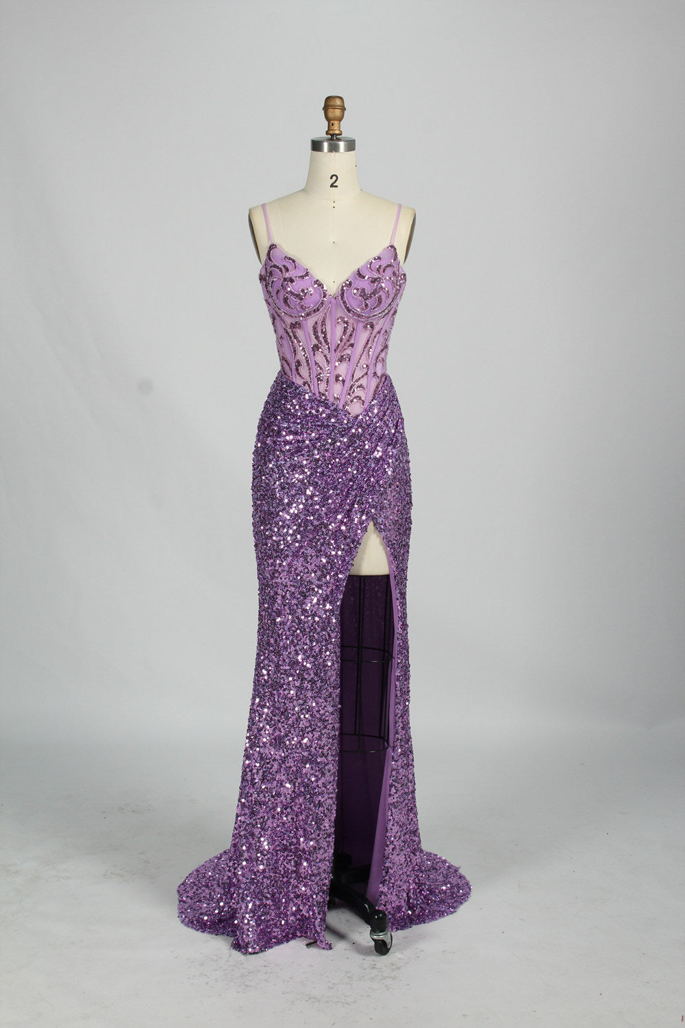Set against a light background, a mannequin presents a blue gown adorned with sequins. It has thin straps, a deep V - neckline, and a mermaid - shaped skirt with a high side slit. The intricate sequin patterns and sheer bodice with embroidery add glamour, ideal for proms or formal dinners.9
