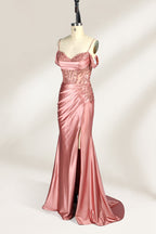 A mannequin displays a rose - gold satin gown. It has thin straps, off - shoulder lace - detailed sleeves, a ruched bodice, and a high side slit. The elegant design, blending satin and lace, suits formal events like galas or weddings.4