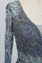 Light blue beaded tulle dress sleeve close-up with sparkling sequins and embroidery