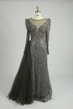 Dark charcoal long-sleeve mermaid gown with V-neckline, beaded lace, and side drape