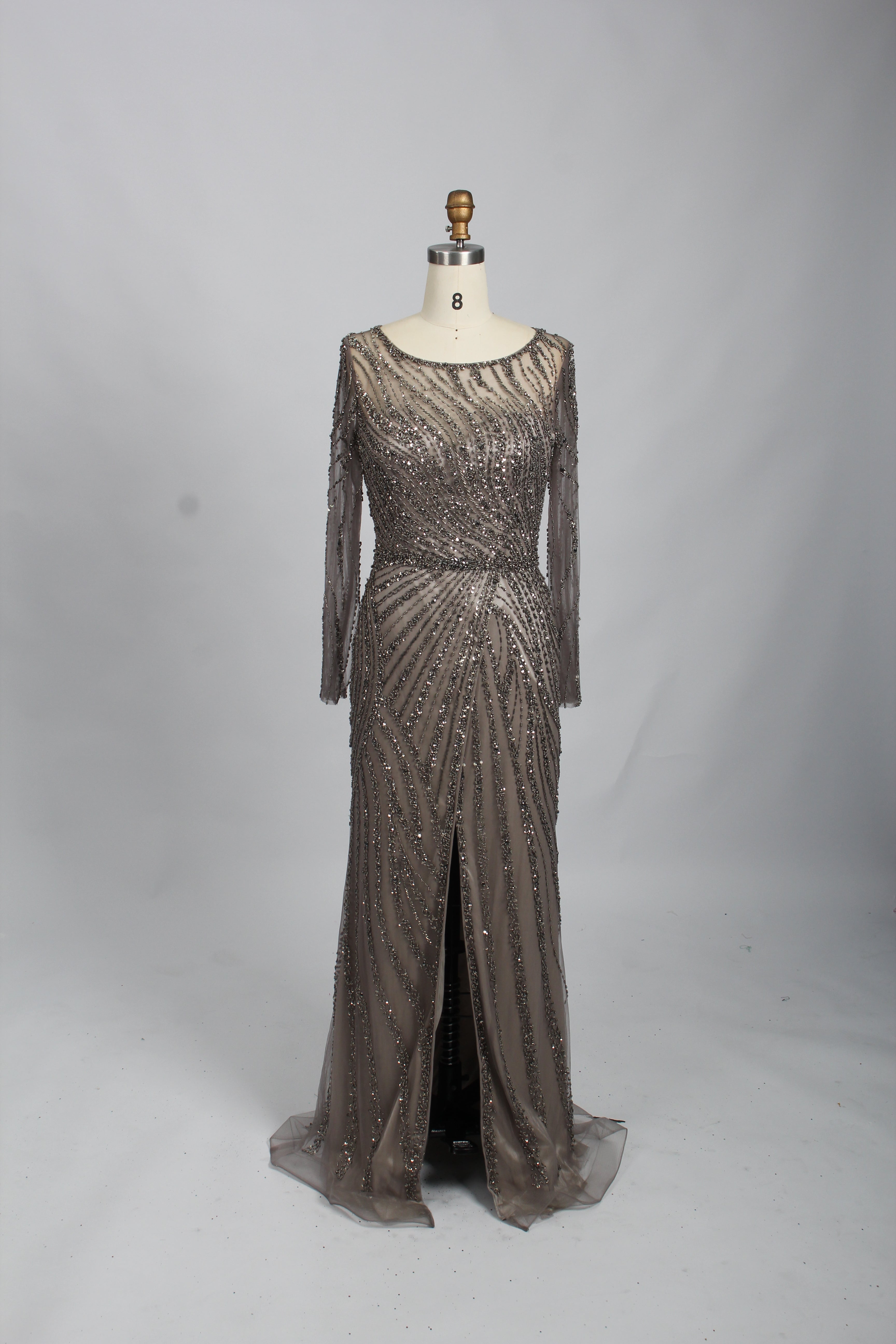 Sparkly grey beaded sheath mother gown with illusion neckline, long sleeves, and front slit