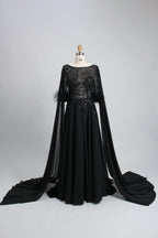 Black sequin evening dress with cape sleeves and feather-trim cuffs, full skirt