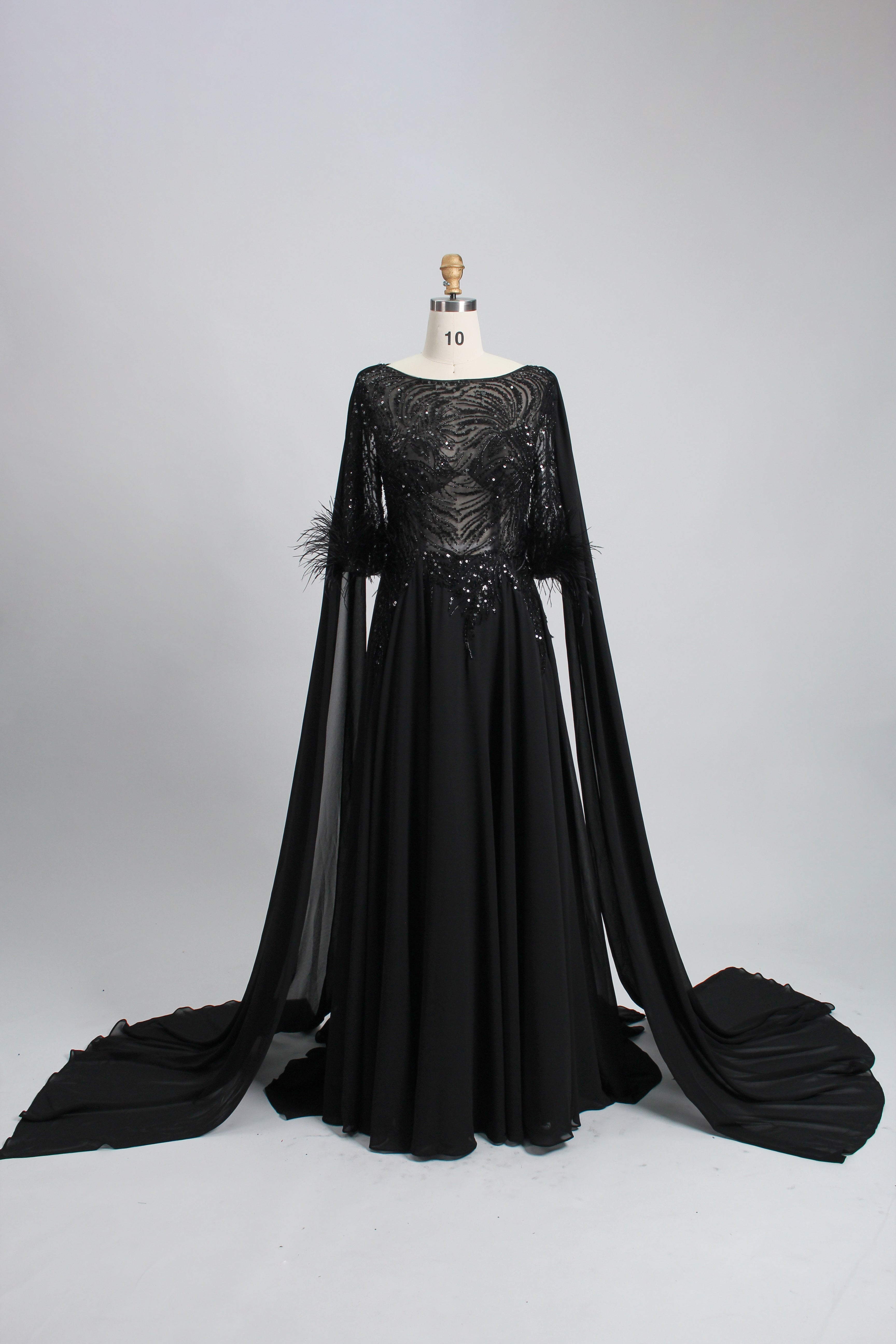 Black sequin evening dress with cape sleeves and feather-trim cuffs, full skirt