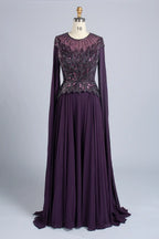 Dark purple A-line chiffon gown with beaded V-neck bodice and long sleeves