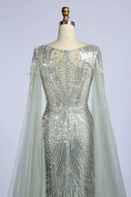 Silver beaded back cape fit-and-flare gown with sheer sleeves and embellished bodice