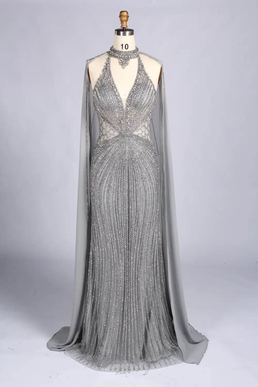 Silver beaded halter mermaid gown with sheer cape overlay and V-neck sparkle