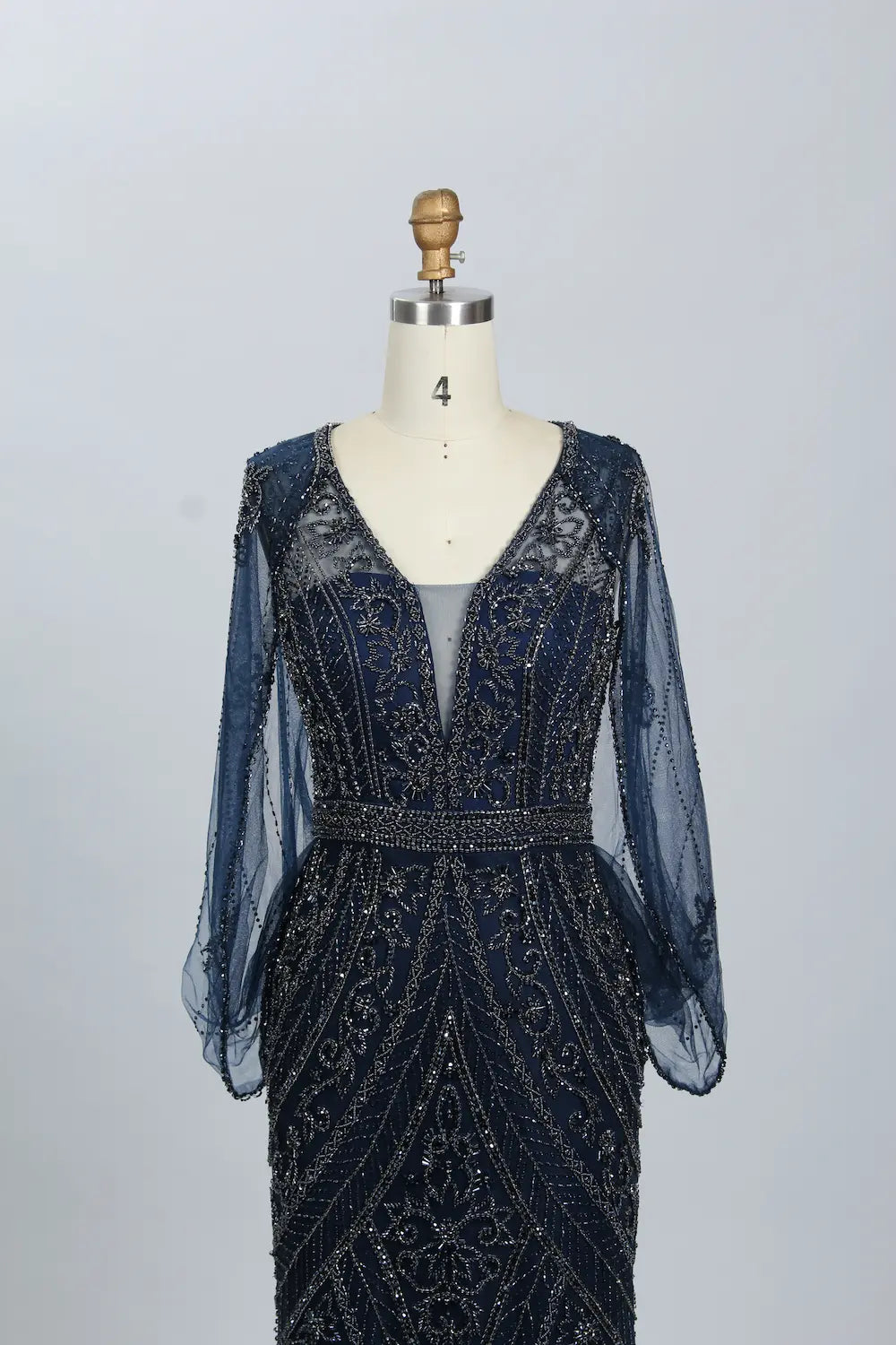 Navy beaded V-neck mermaid dress with sheer sleeves, fitted waist, and geometric motifs
