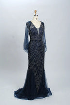Navy beaded V-neck mermaid gown with sheer long sleeves and flowing tulle hem