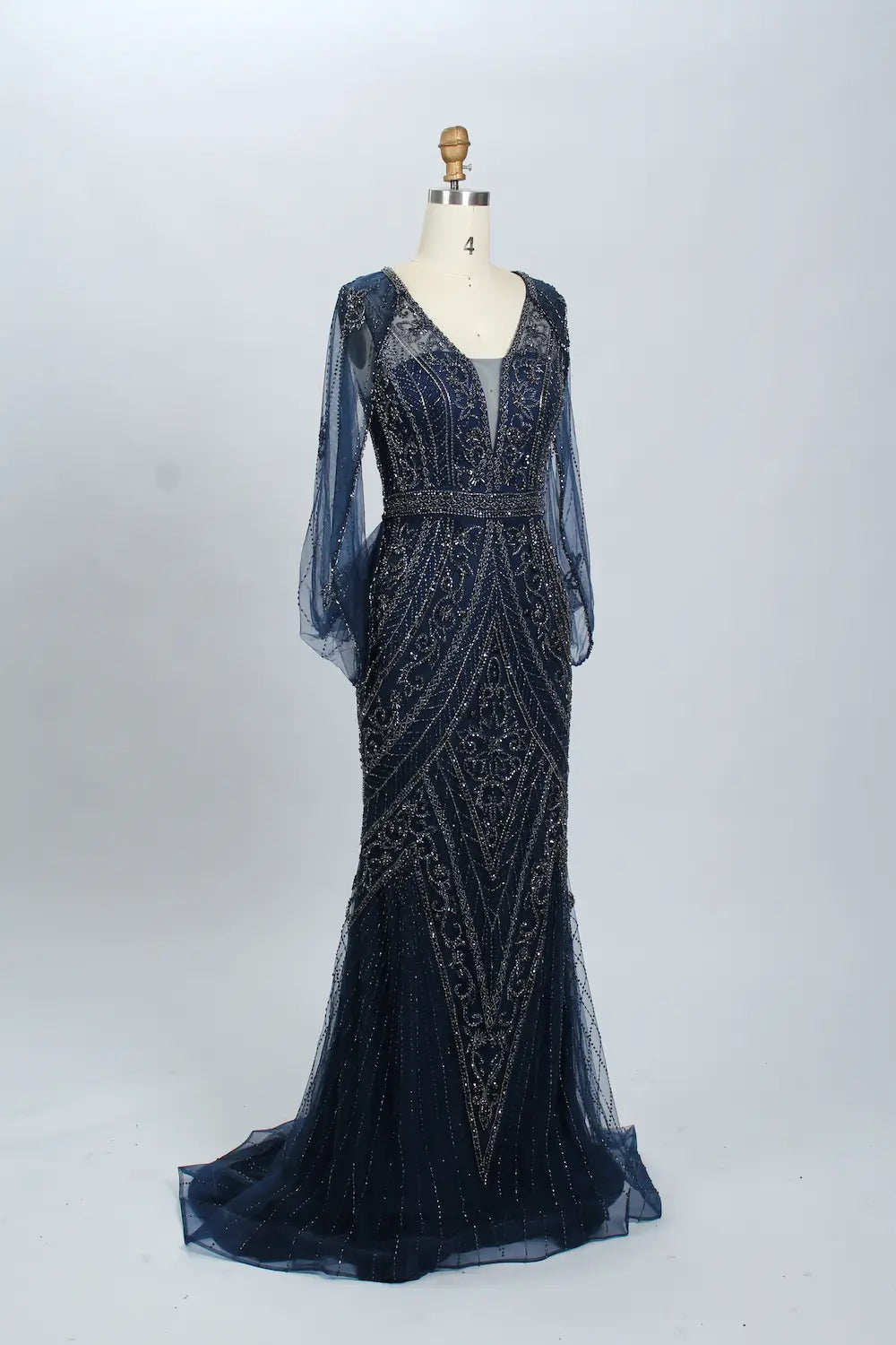 Navy beaded V-neck mermaid gown with sheer long sleeves and flowing tulle hem