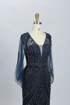 Navy beaded V-neck mermaid gown with sheer sleeves and intricate lace-like bead patterns