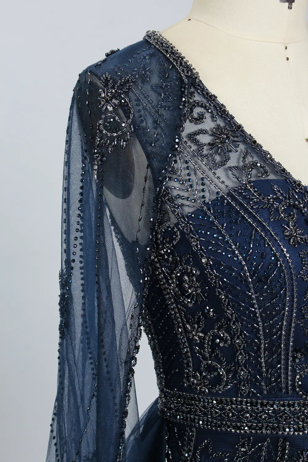 Navy beaded sheer sleeve panel with intricate floral motifs and sparkling accents