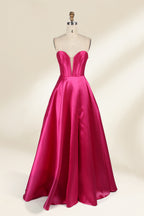 A mannequin showcases a magenta - satin gown. It has an off - the - shoulder, sweetheart neckline, puffed sleeves, and a high side slit. The elegant design, with smooth satin fabric, suits formal events like galas, radiating sophistication.3