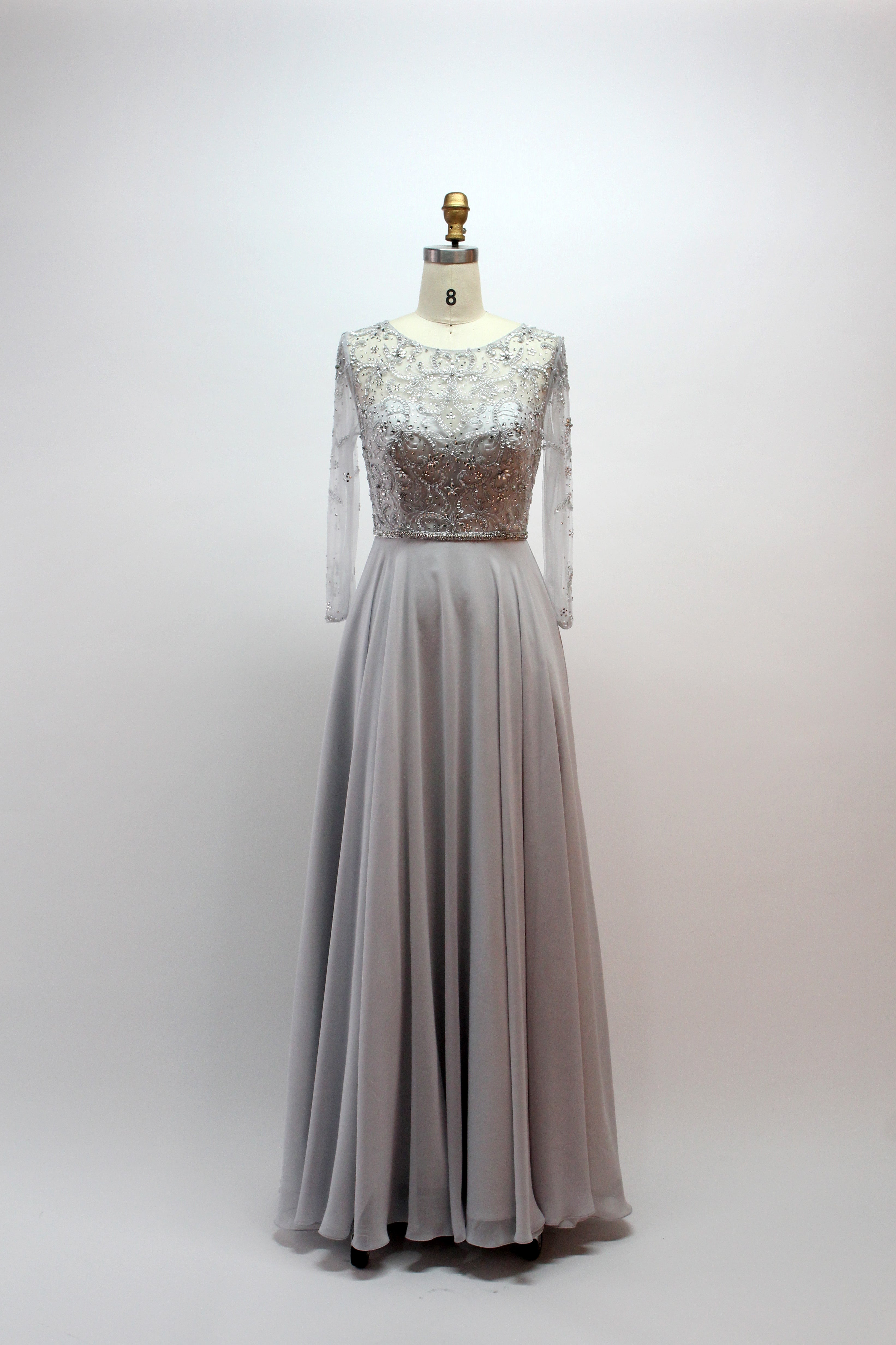 Grey beaded tulle gown with long sleeves, lace bodice, and flowing A-line skirt