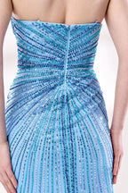 photo of a beautiful woman in a stunning blue ball gown with a plunging neckline and thigh-high slit, standing confidently in a studio with soft, diffused lighting, elegant and glamorous, full-length dress with intricate beadwork, long brunette hair styled in an elegant updo, fair skin, red lipstick, high heels, minimalist white background, fashion photography, stylish and sophisticated, no watermarks.KT1432-07