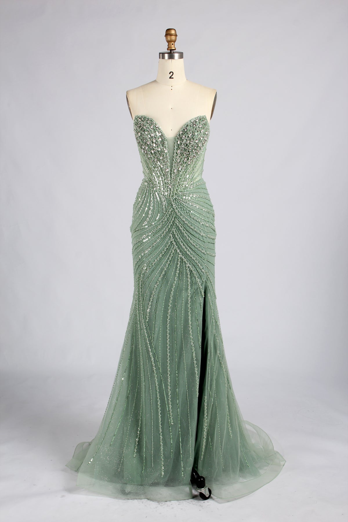 Sage green strapless mermaid prom dress with beaded bodice and flowing skirt